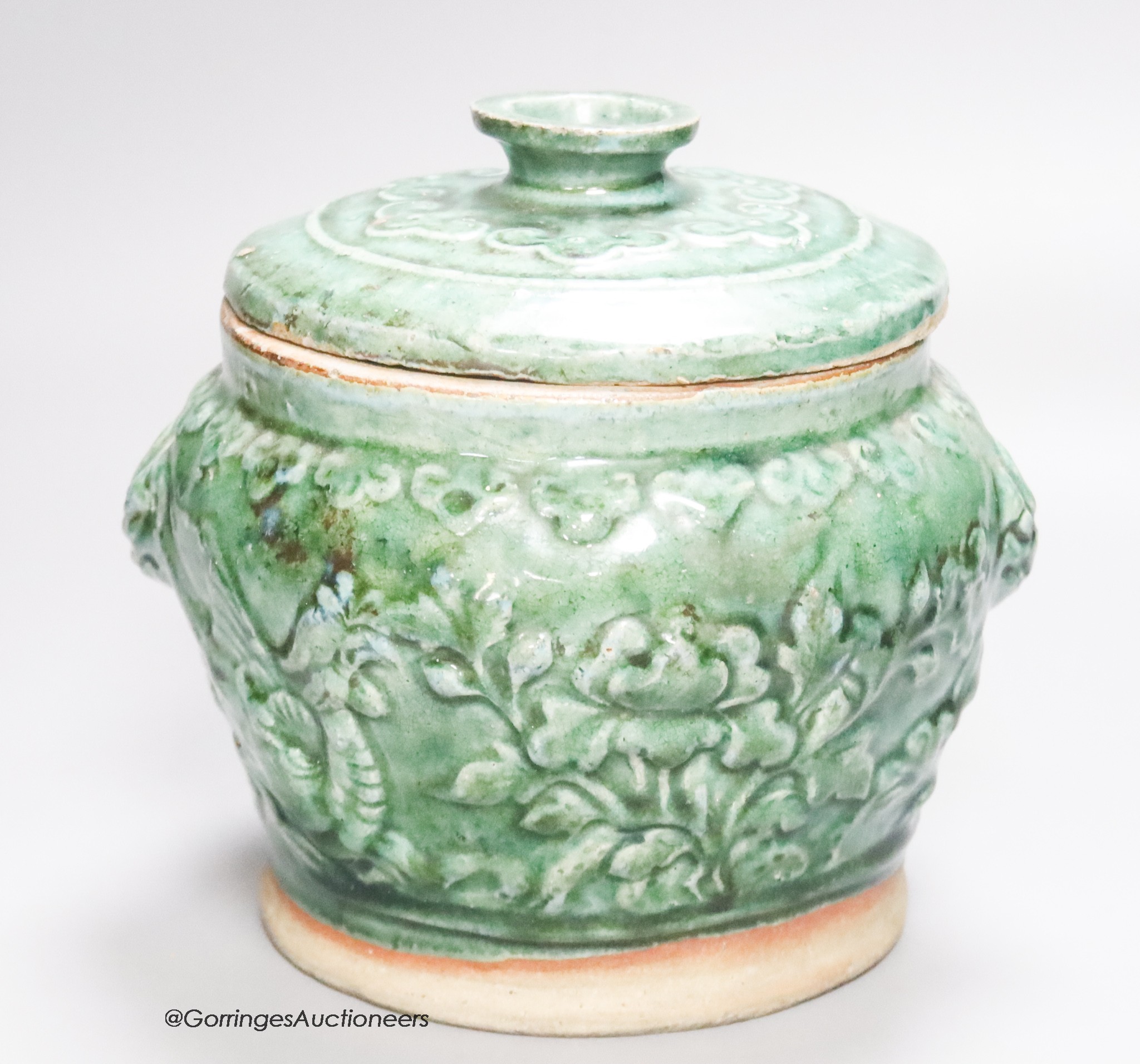 A 19th century Chinese green glazed jar and cover, height 19cm